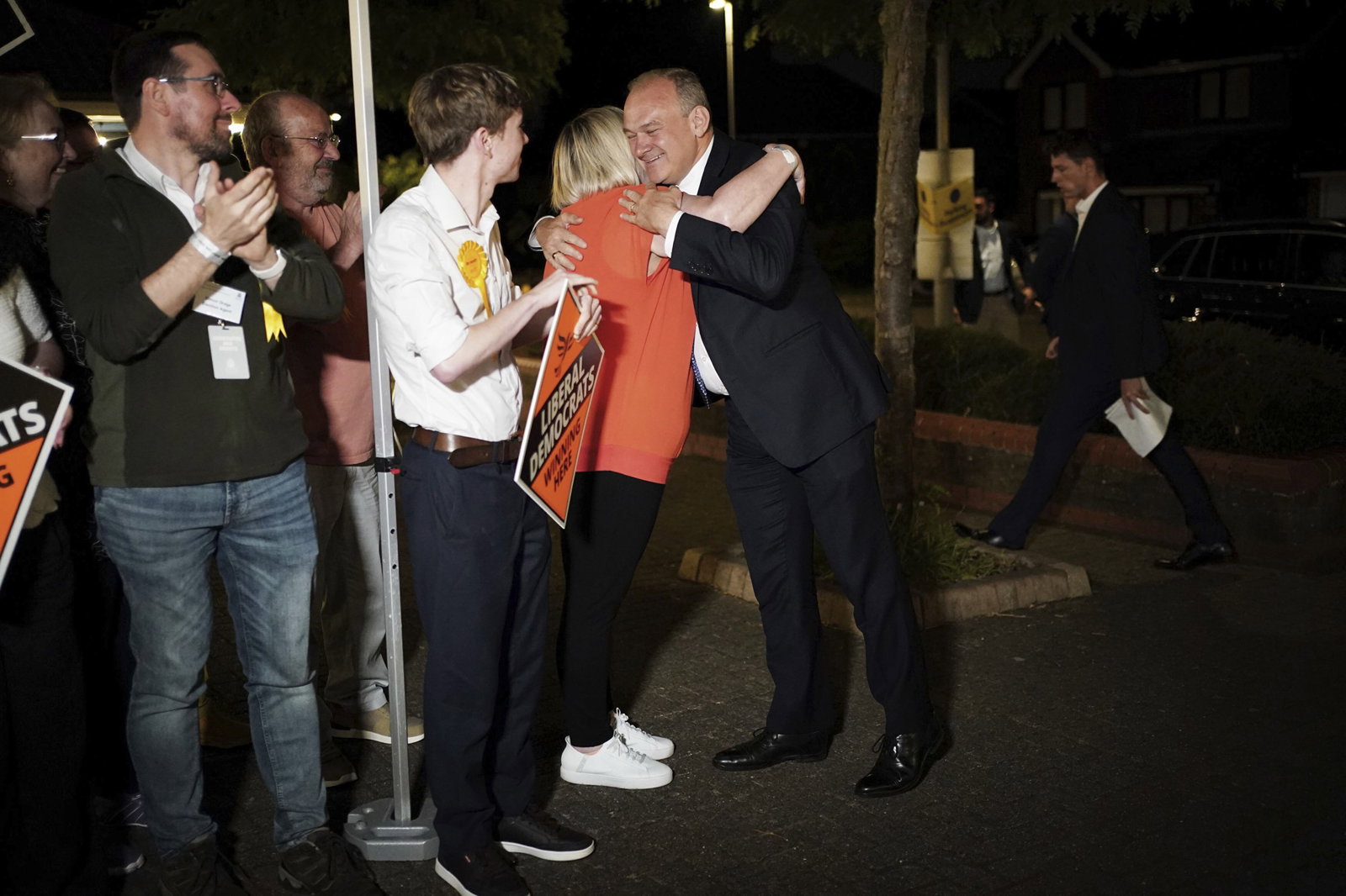 Man being hugged by woman